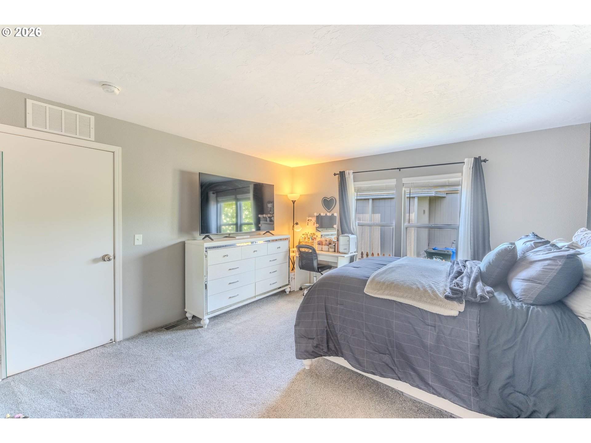 4364 Bren Loop Northeast, Unit 95 Salem, OR 97305 - Photo 26 of 34 a bedroom with a bed and a large window