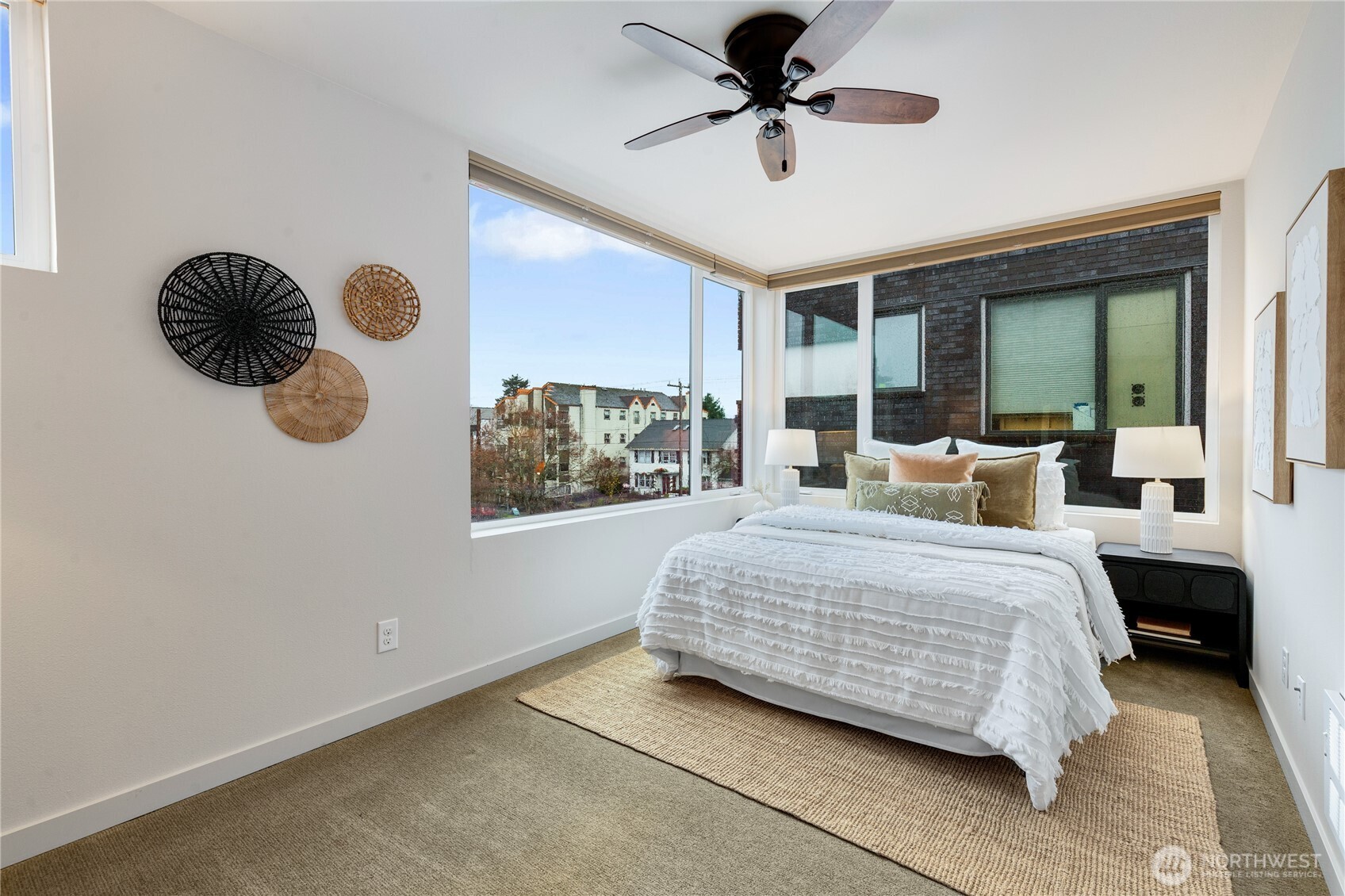 4272 Southwest Bradford Street Seattle, WA 98116 - Photo 19 of 28 a bedroom with a large bed and a chandelier