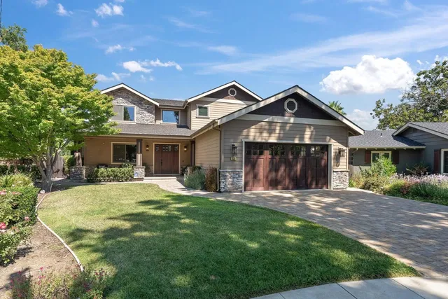 a front view of a house with a garden and porch