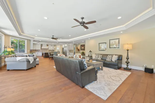 a bathroom with a granite countertop sink a toilet a mirror and shower