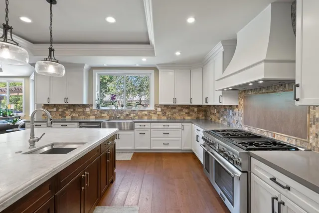 a view of a patio with table and chairs potted plants and palm trees