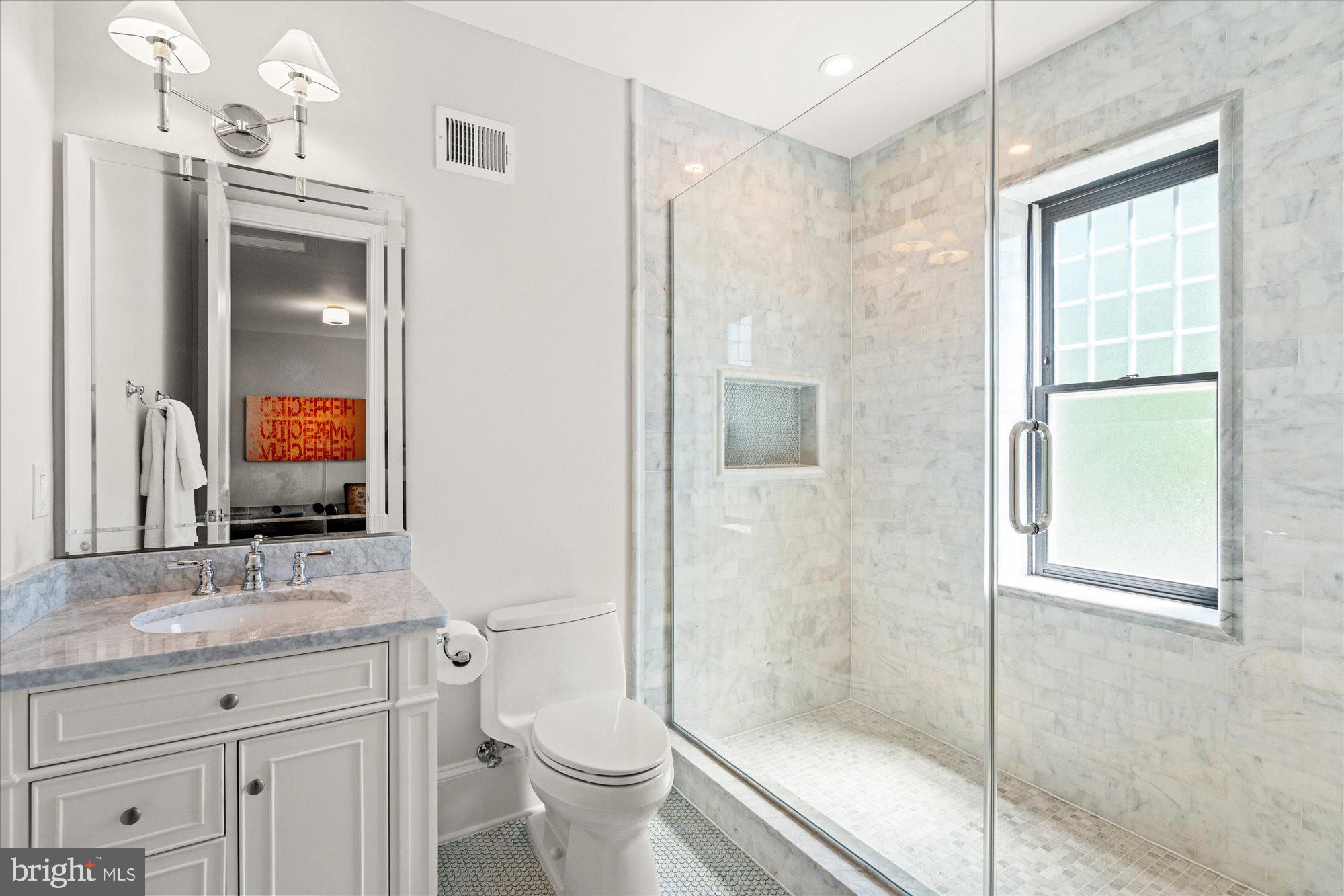 2610 Garfield Street Northwest Washington, DC 20008 - Photo 36 of 51 a bathroom with a granite countertop sink toilet and shower