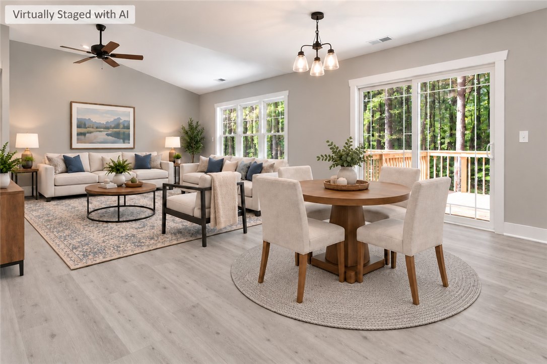 1747 A State Rd S-4-97 Anderson, SC 29621 - Photo 14 of 47 Vaulted ceilings and wide-plank flooring define this open living and dining layout with deck access.