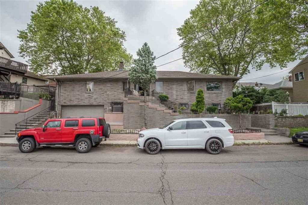 a white car parked in front of a house