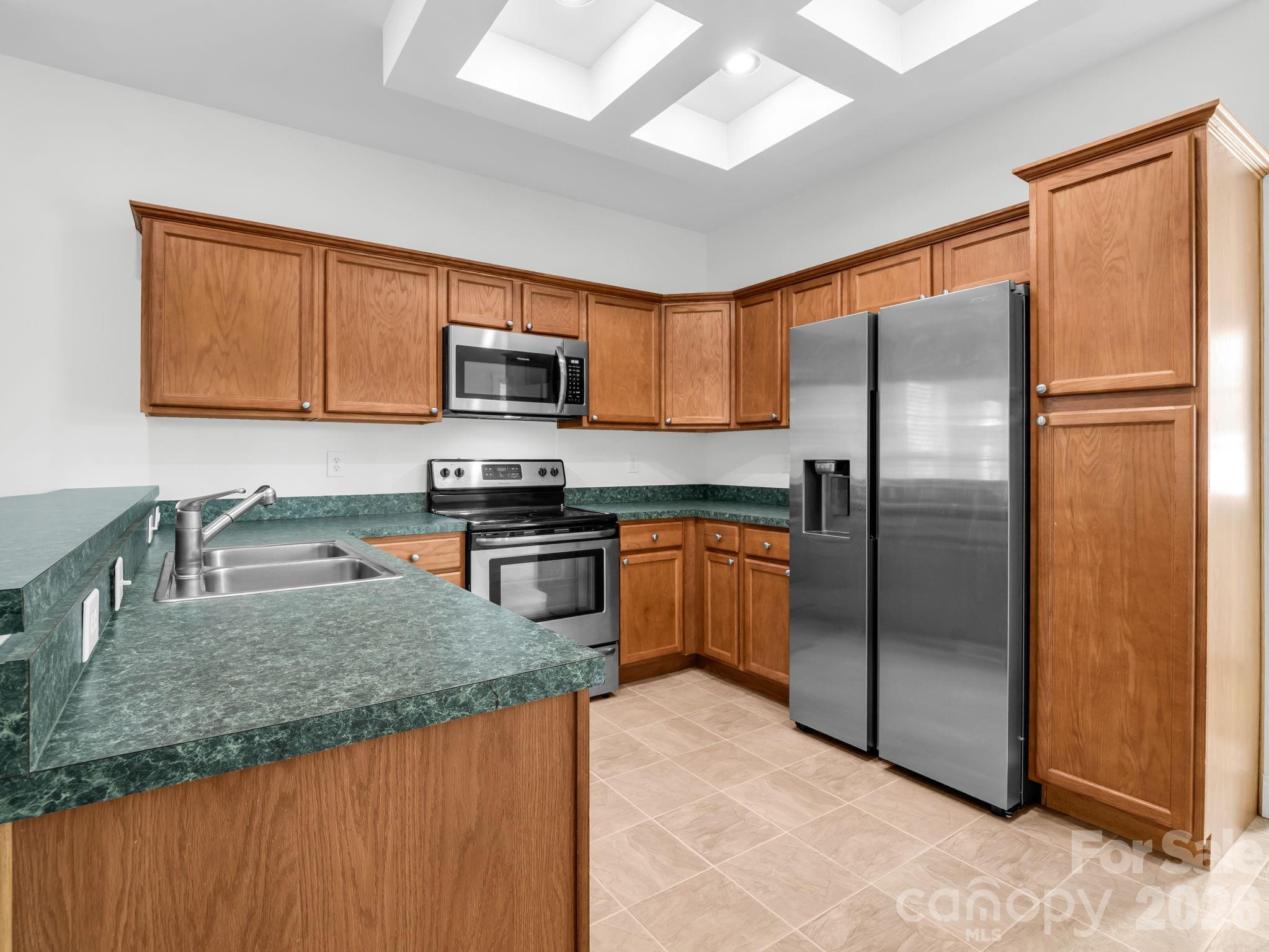 19 Lynnbrook Way Columbus, NC 28722 - Photo 13 of 45 a kitchen with granite countertop a refrigerator and a sink