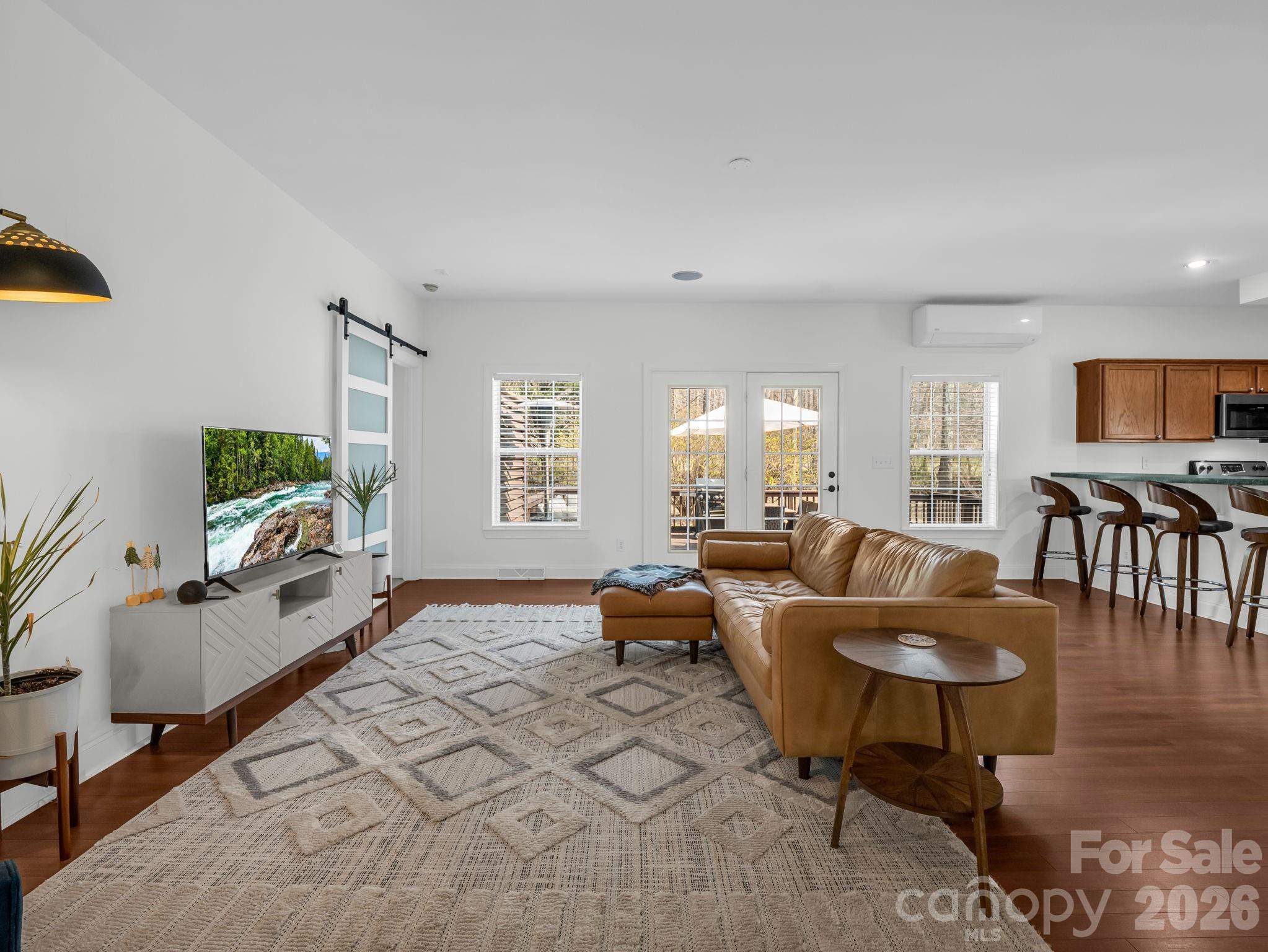 19 Lynnbrook Way Columbus, NC 28722 - Photo 8 of 45 a living room with furniture a wooden floor and a flat screen tv