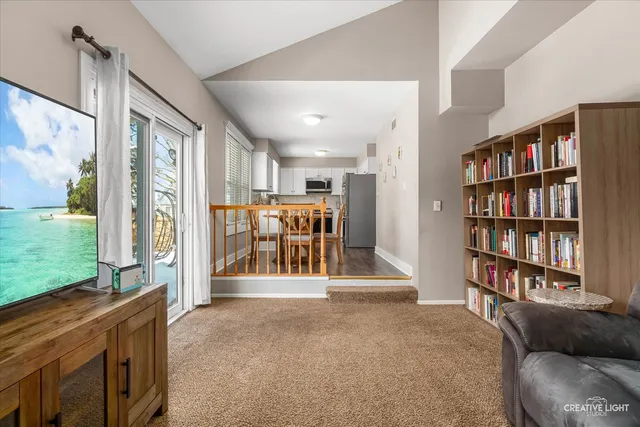a view of a livingroom with furniture and staircase