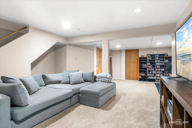 a living room with furniture and kitchen view