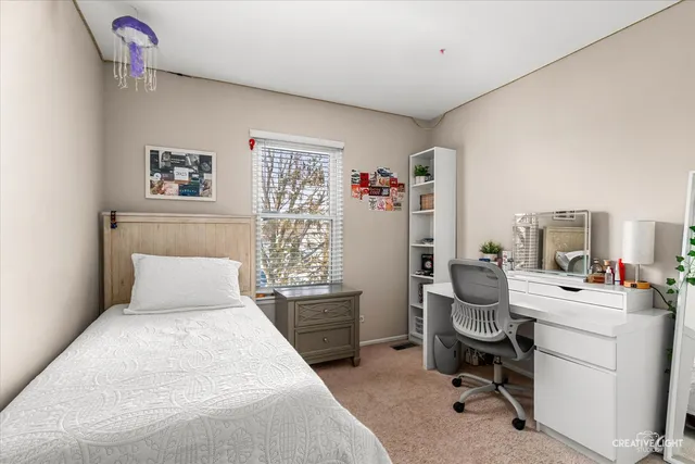 a bedroom with a bed and a desk