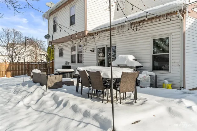 a view of a patio with a table and chairs