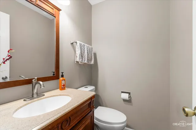 a bathroom with a sink a toilet and mirror