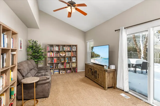 a living room with furniture and a bookshelf