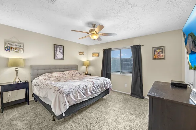 a bedroom with a bed and a desk