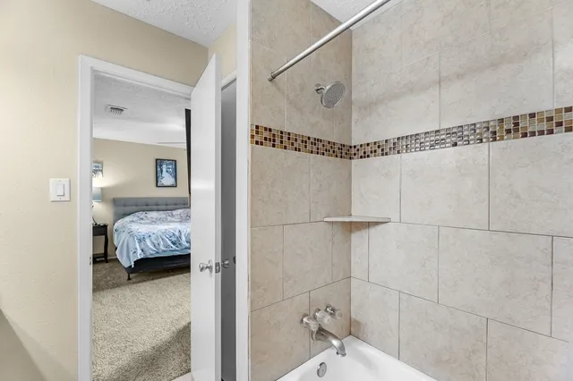 a en suite bathroom with a shower and a sink