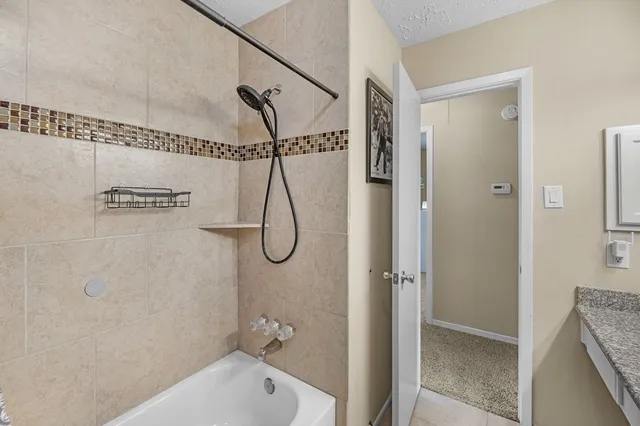 a bathroom with a bath tub with a shower