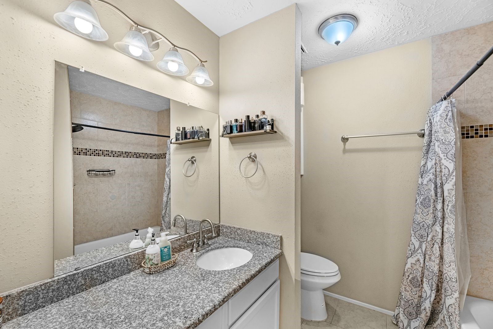 20931 Fernhollow Lane Spring, TX 77388 - Photo 18 of 24 a bathroom with a granite countertop sink toilet and shower