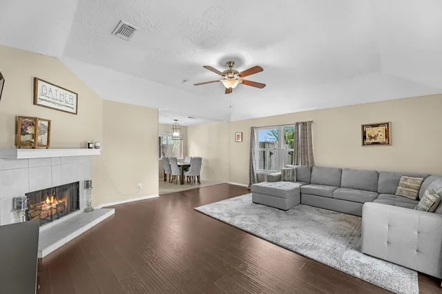 a living room with furniture and a fireplace