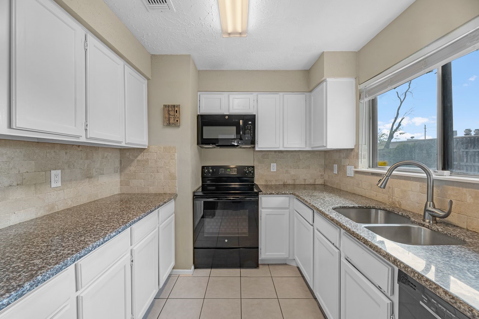 20931 Fernhollow Lane Spring, TX 77388 - Photo 8 of 24 a kitchen with granite countertop a sink stove top oven and cabinets
