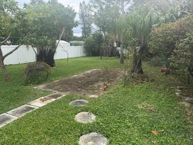 a backyard of a house with outdoor seating and green space