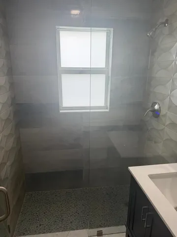 a bathroom with a sink a vanity and a window