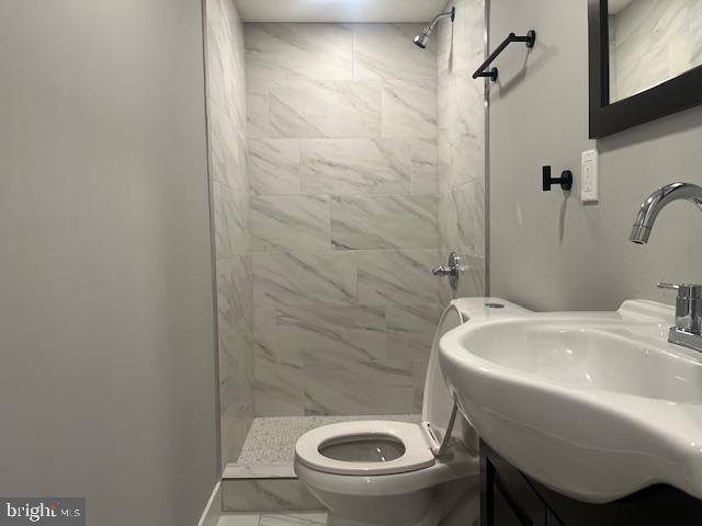 6339 Morton Street, Unit G Philadelphia, PA 19144 - Photo 6 of 10 a bathroom with a sink a toilet and shower