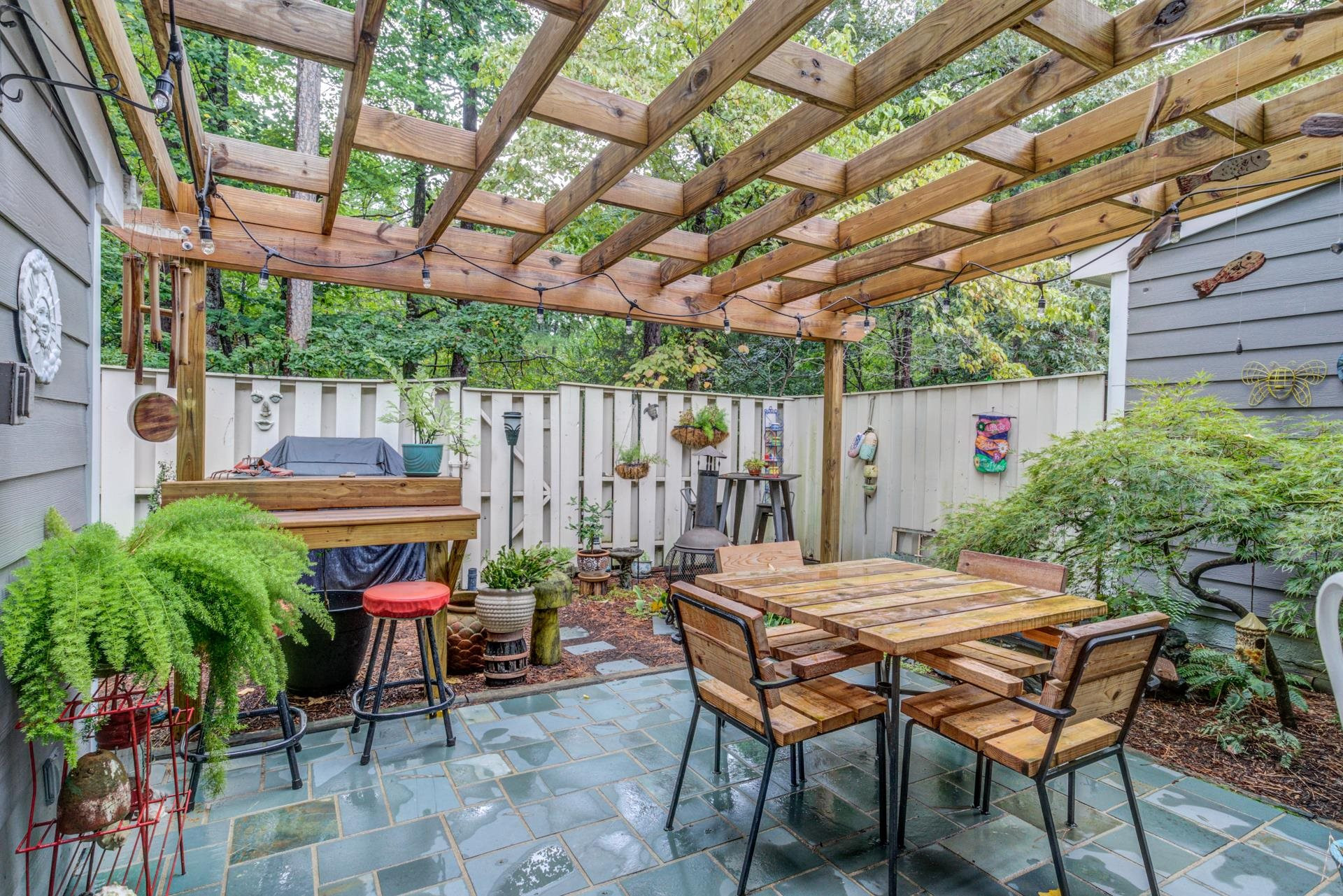 817 Green Ridge Drive Raleigh, NC 27609 - Photo 21 of 24 Private patio with fish pond, pergola, built in bar, grilling pad, fence and storage. Great place for your morning coffee or having friends over for a barbeque. Patio