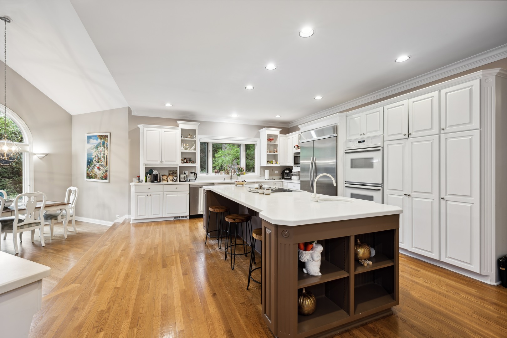 310 Belle Foret Drive Lake Bluff, IL 60044 - Photo 11 of 31 a kitchen with stainless steel appliances kitchen island granite countertop a stove a refrigerator a sink dishwasher and a dining table with wooden floor