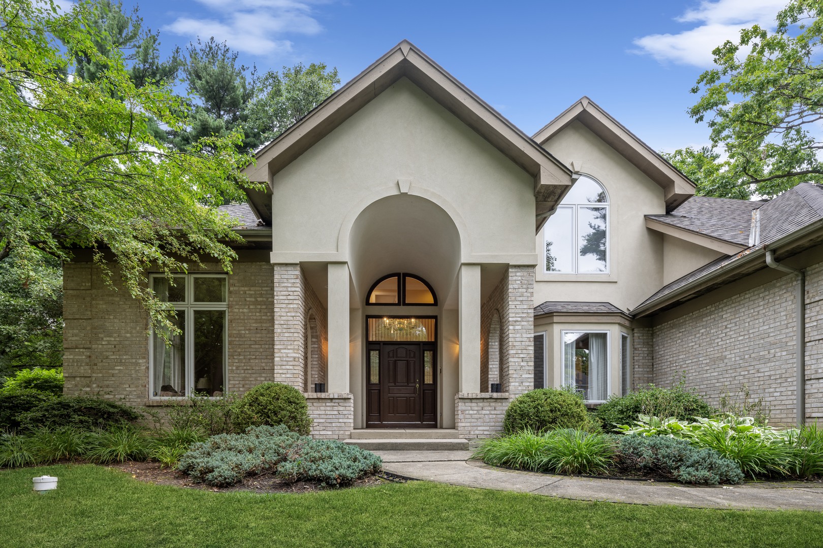 310 Belle Foret Drive Lake Bluff, IL 60044 - Photo 2 of 31 a front view of a house with a garden