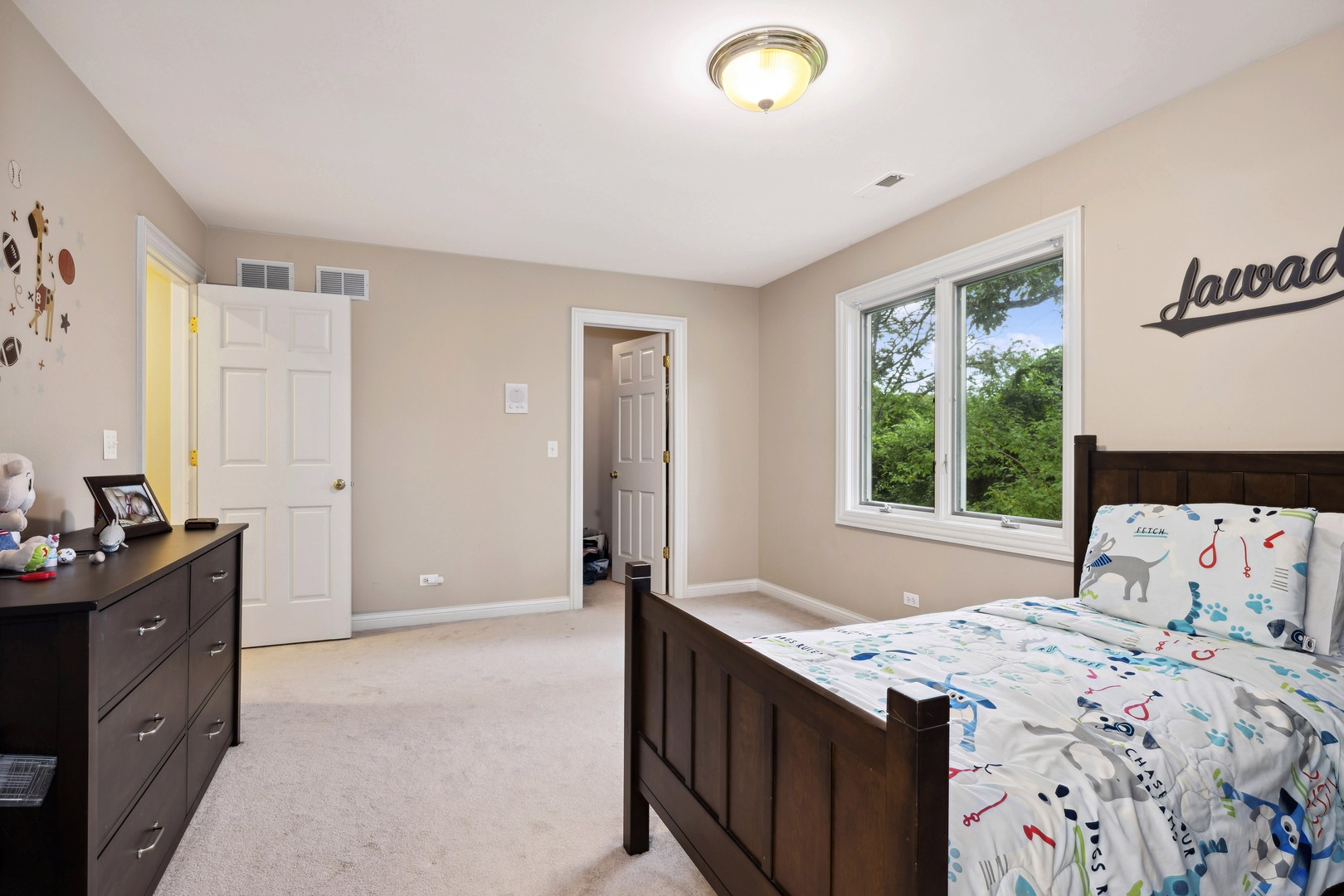 310 Belle Foret Drive Lake Bluff, IL 60044 - Photo 23 of 31 a bedroom with a dresser and a window