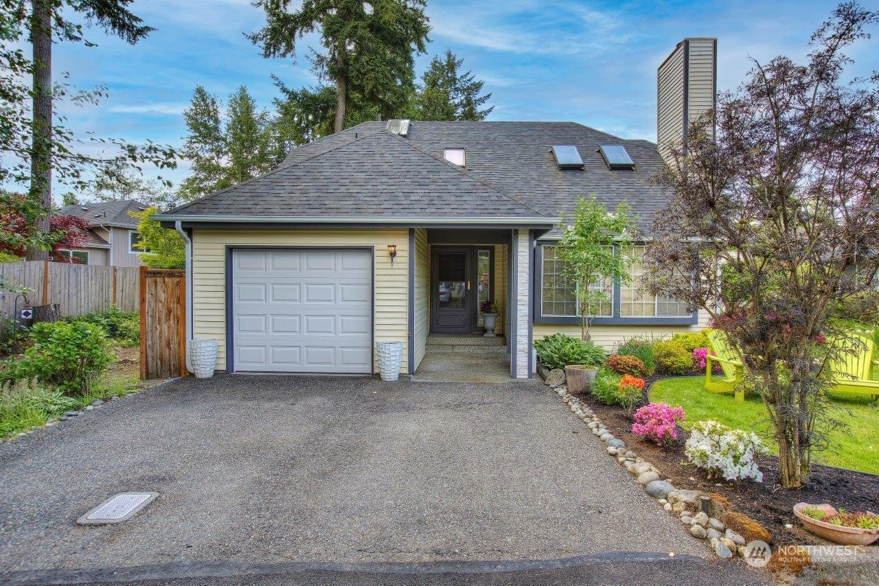 a front view of a house with a garden