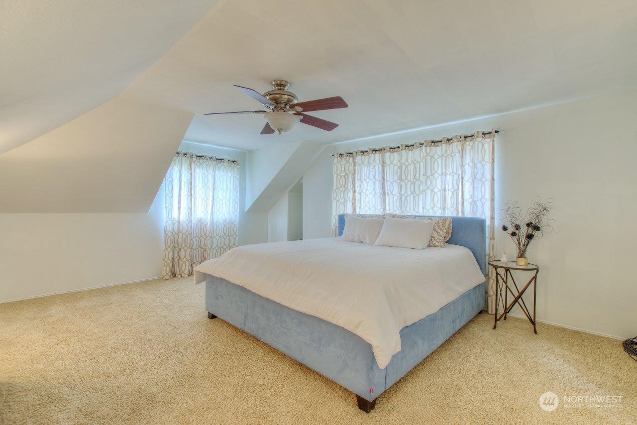 32911 4th Lane South Federal Way, WA 98003 - Photo 13 of 19 a spacious bedroom with a bed and a chandelier
