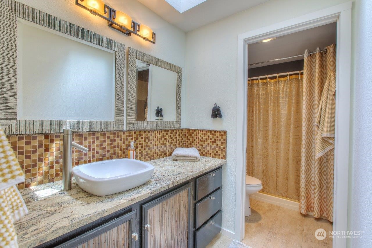 32911 4th Lane South Federal Way, WA 98003 - Photo 16 of 19 a bathroom with a granite countertop sink and a mirror