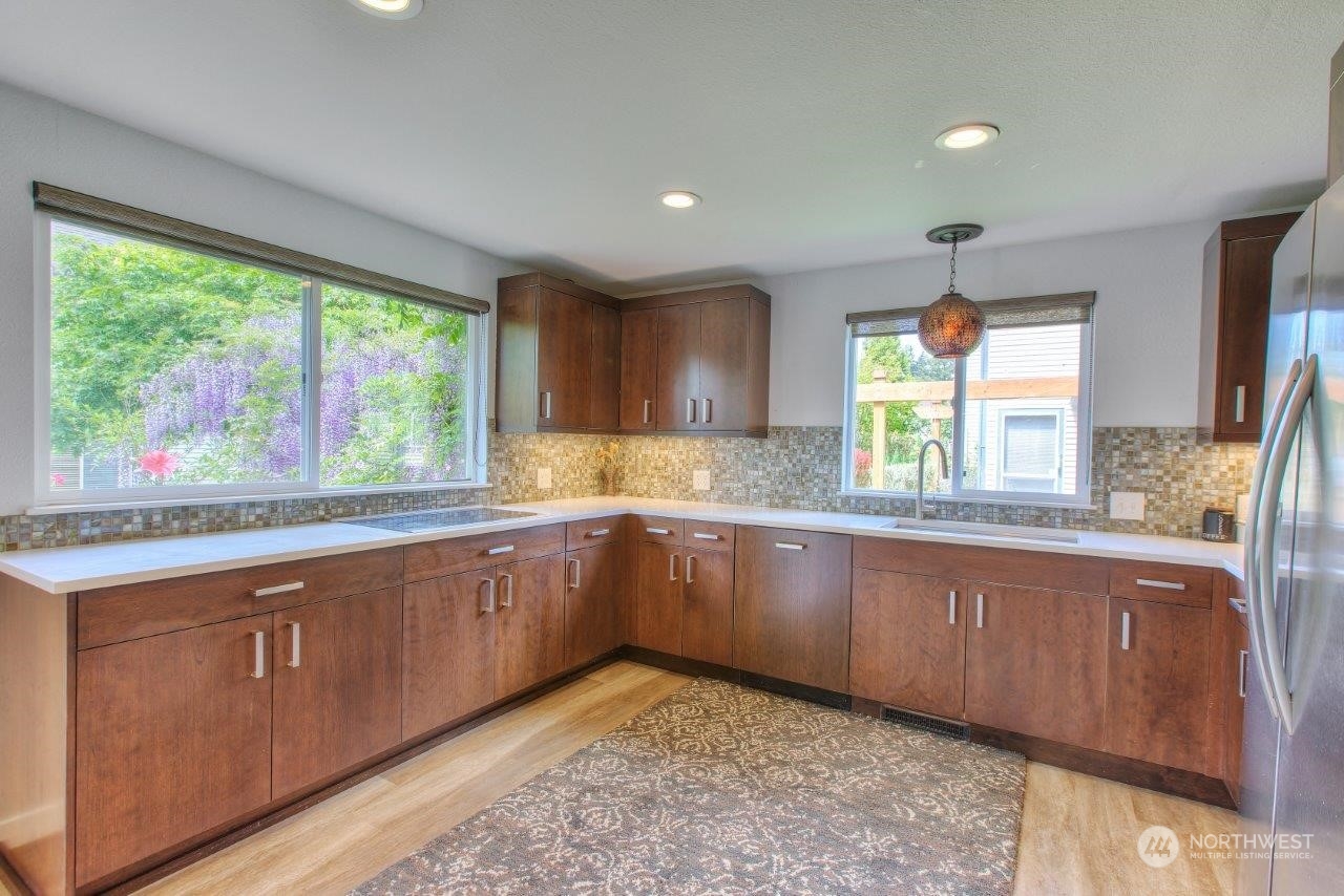 32911 4th Lane South Federal Way, WA 98003 - Photo 6 of 19 a large kitchen with stainless steel appliances granite countertop a sink and a stove