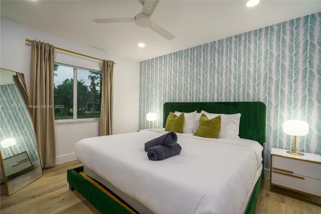 a bedroom with a bed and a large window