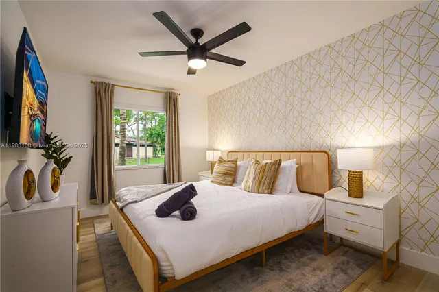 a bedroom with a bed a dresser next to a window