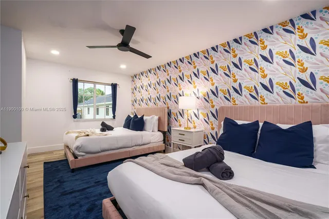 a bedroom with two beds and a chandelier