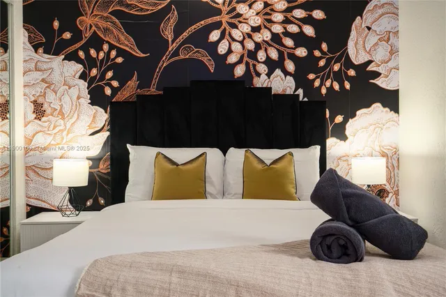 a bedroom with a bed and teddy bear on the dresser