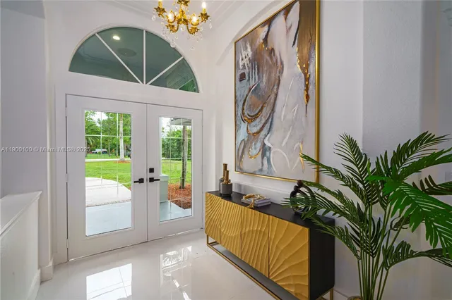 a living room with a couch and a potted plant