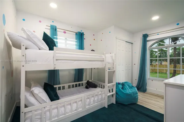 a bedroom with furniture and a large window