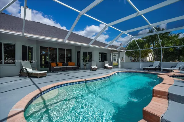a view of a backyard with sitting area