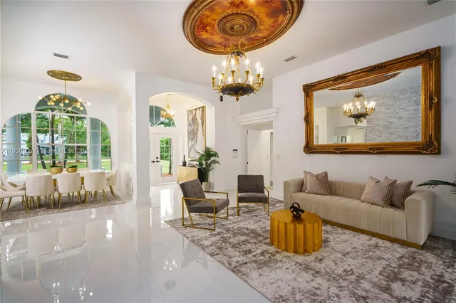 a living room with furniture and a chandelier