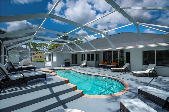 a view of a backyard with furniture and a patio