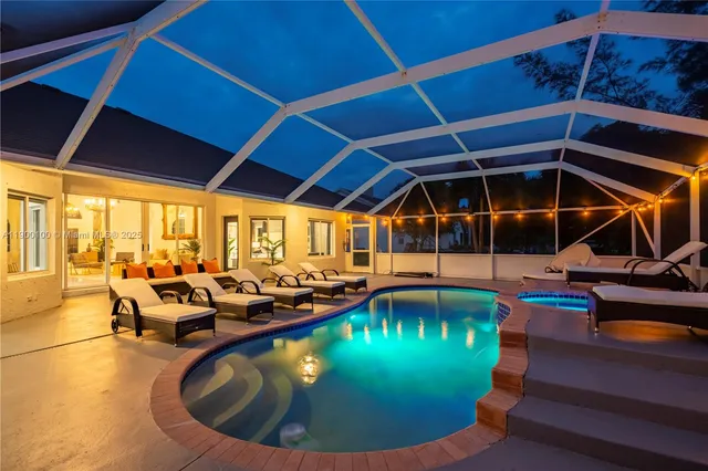 a view of a swimming pool with outdoor seating
