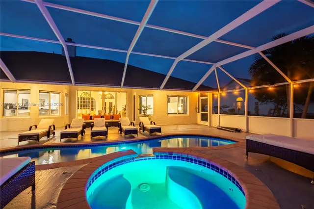 an aerial view of a house with a swimming pool