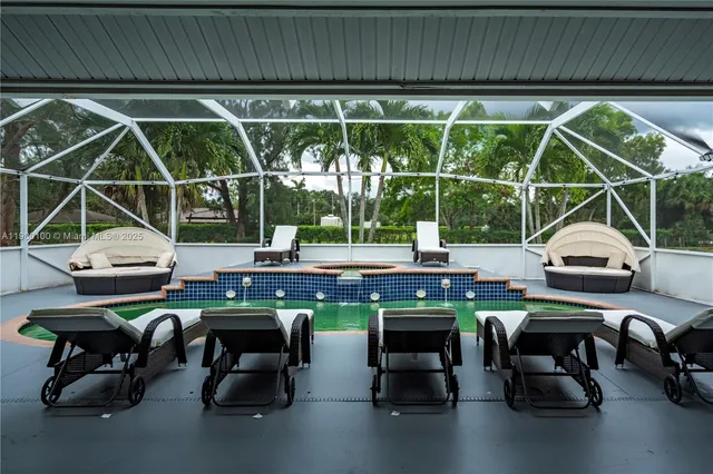 a swimming pool with an outdoor space and seating area