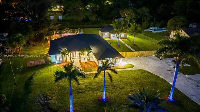 an aerial view of a house with a swimming pool