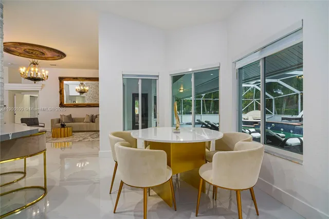 a dining room with furniture and a large window