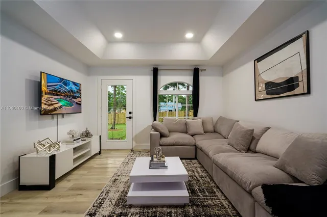 a living room with furniture and a flat screen tv