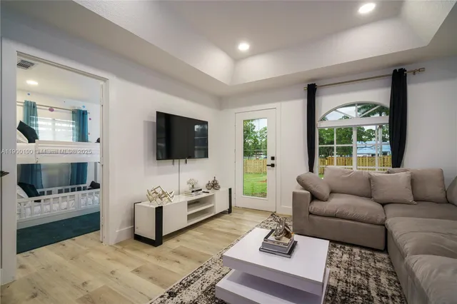 a living room with furniture and a flat screen tv