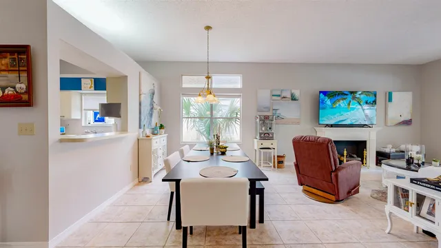 a living room with fireplace furniture and a large window